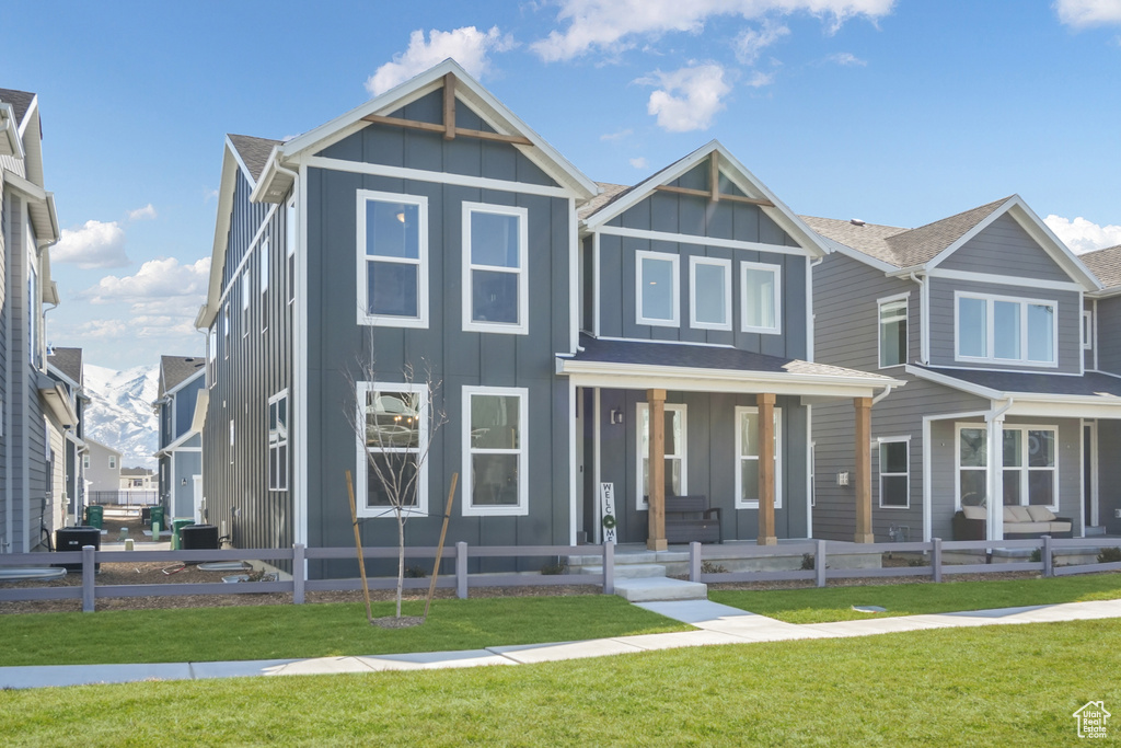 View of front of house featuring board and batten siding and covered porch