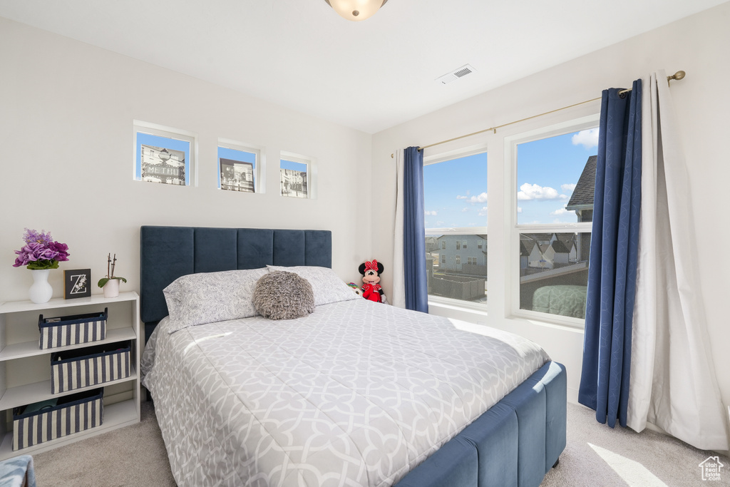 Bedroom with light carpet