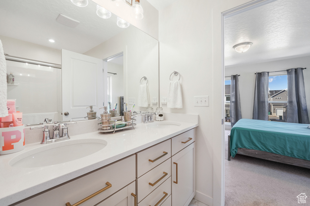 Ensuite bathroom featuring double vanity