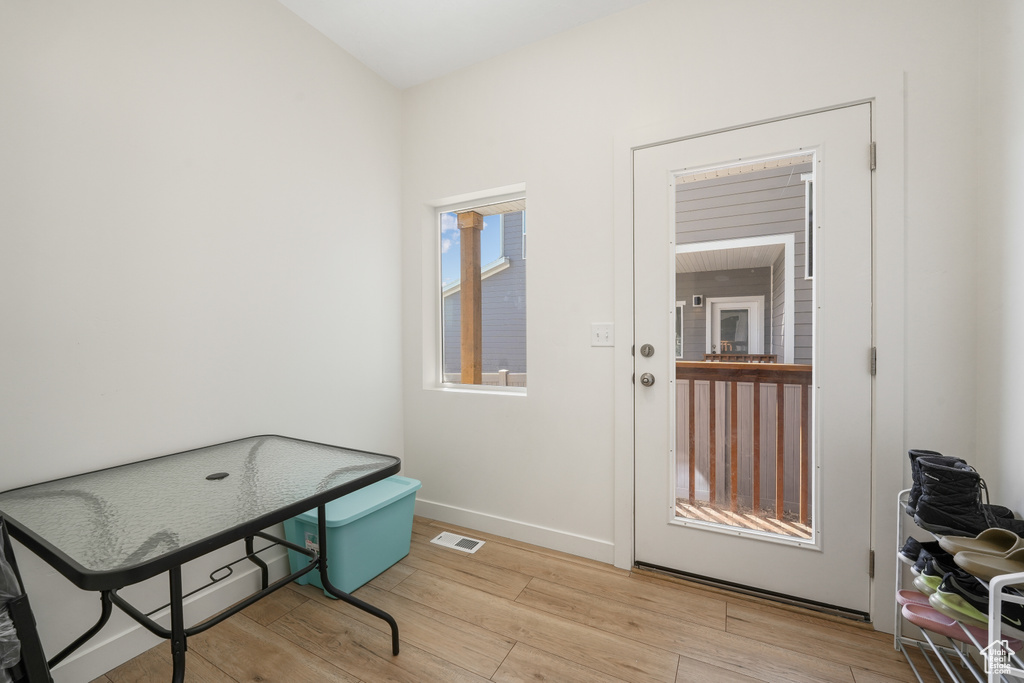 Entryway with wood finished floors and baseboards