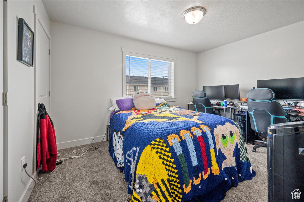 Carpeted bedroom with baseboards