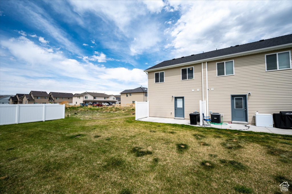 Rear view of property with a patio, a residential view, and central air condition unit