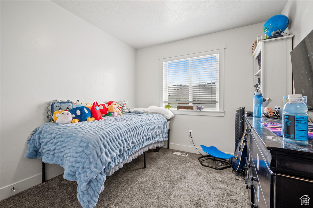 Bedroom featuring carpet floors and baseboards