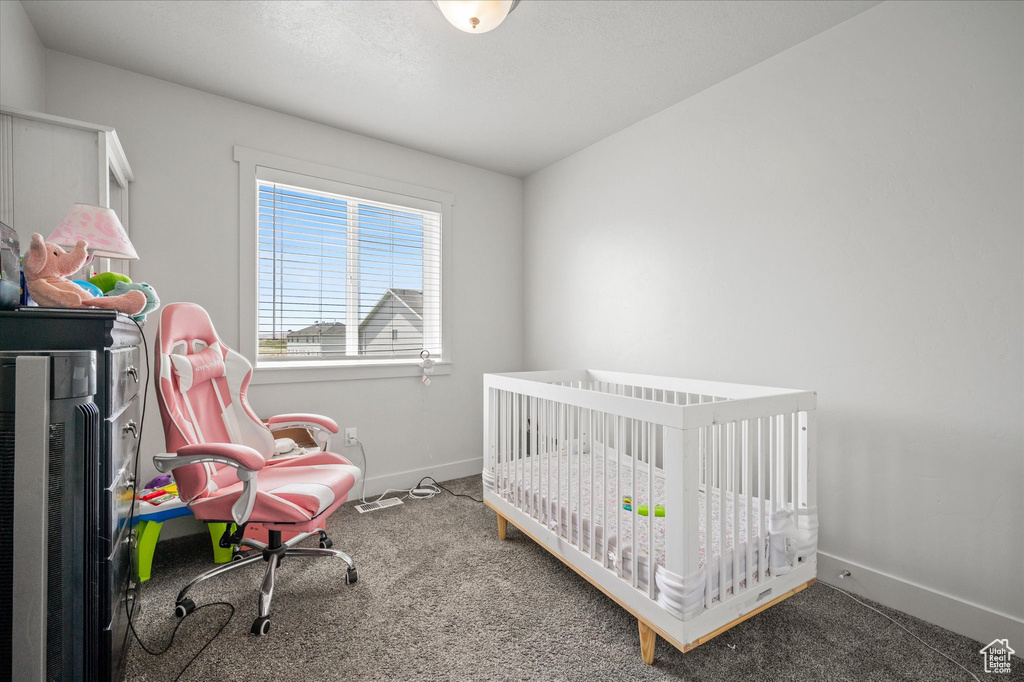 Carpeted bedroom with baseboards