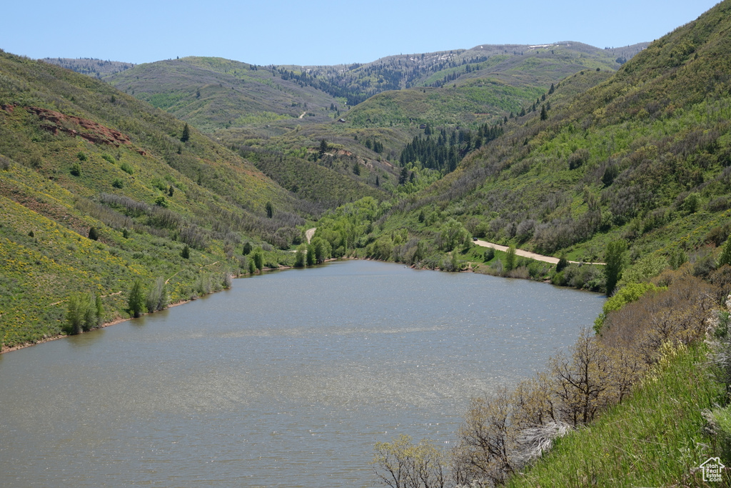 Water view featuring a forest and mountains