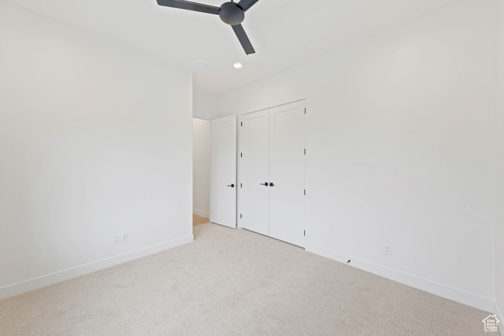 Unfurnished bedroom featuring baseboards, carpet floors, recessed lighting, a closet, and ceiling fan