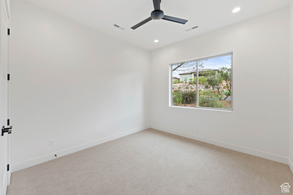 Unfurnished room featuring light colored carpet, a ceiling fan, baseboards, and recessed lighting