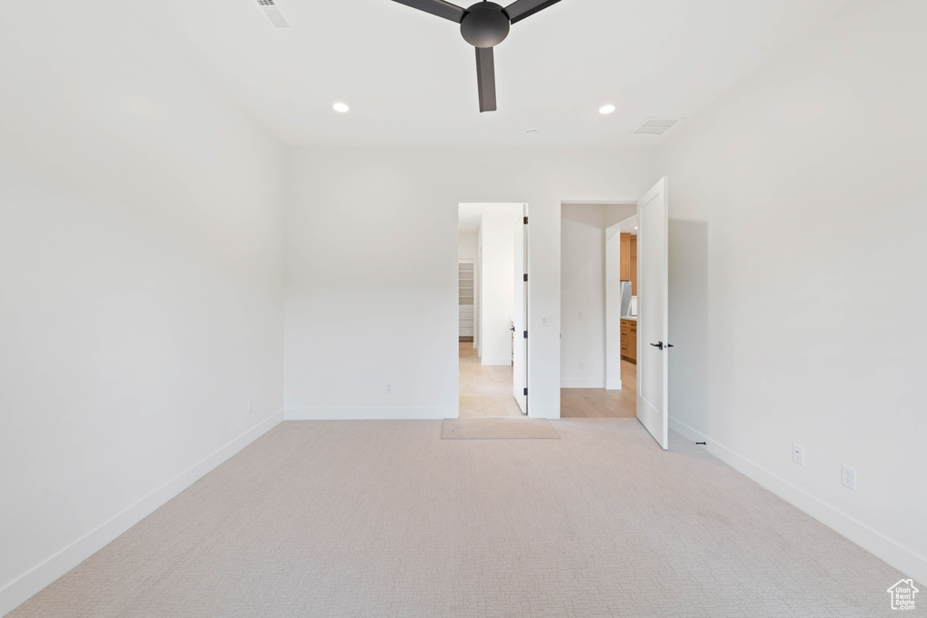 Unfurnished room with baseboards, light colored carpet, and recessed lighting