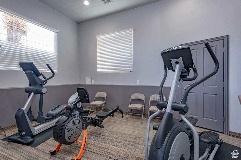 Exercise room with carpet flooring and recessed lighting