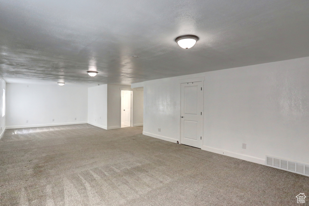 Basement featuring carpet floors and baseboards