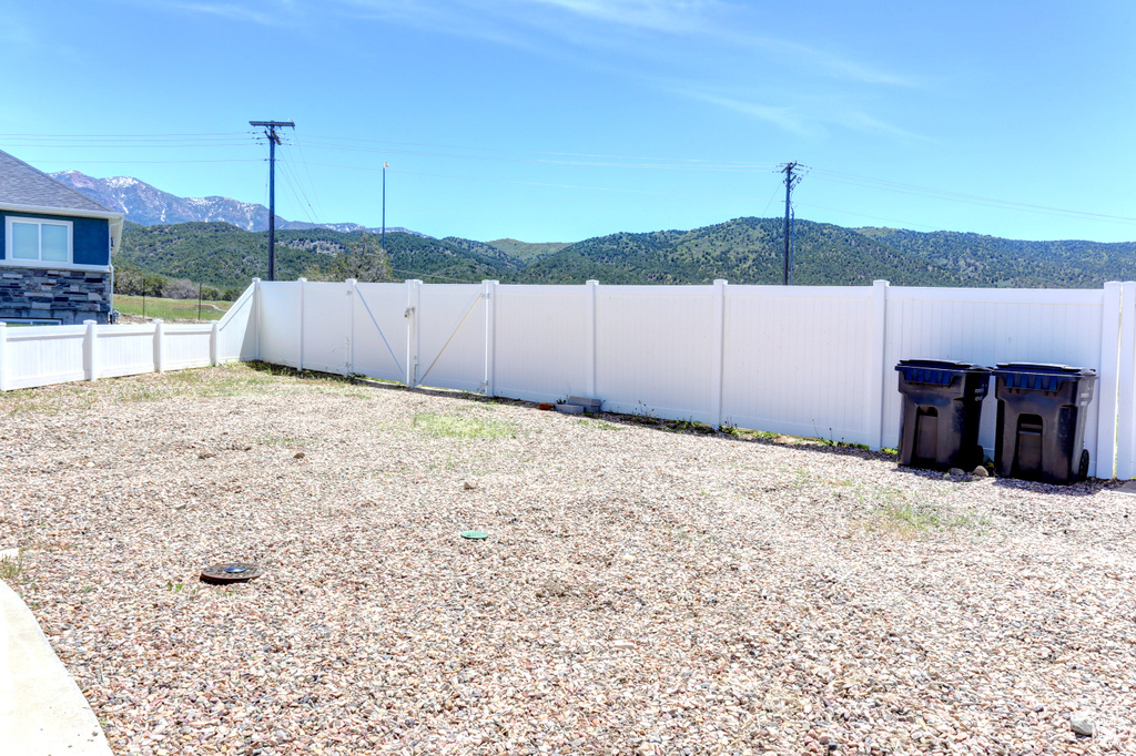Fenced backyard with a mountain view