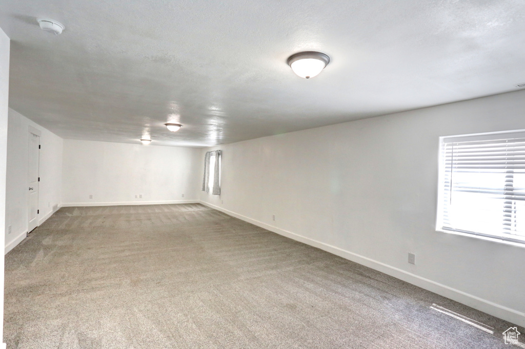 Below grade area featuring carpet floors and baseboards