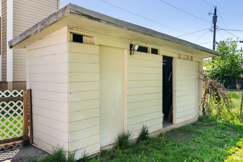 View of outdoor structure with fence and an outdoor structure