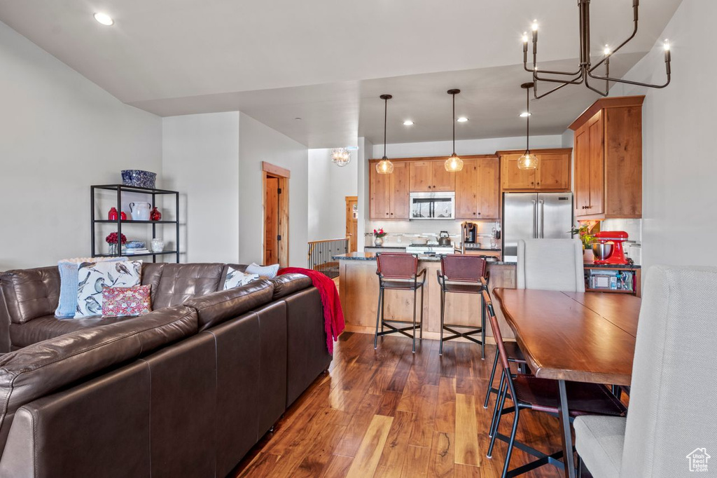 Living area featuring recessed lighting, an inviting chandelier, and dark wood-style floors