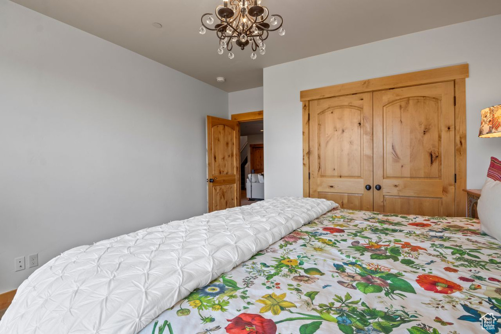 Bedroom with a notable chandelier and a closet