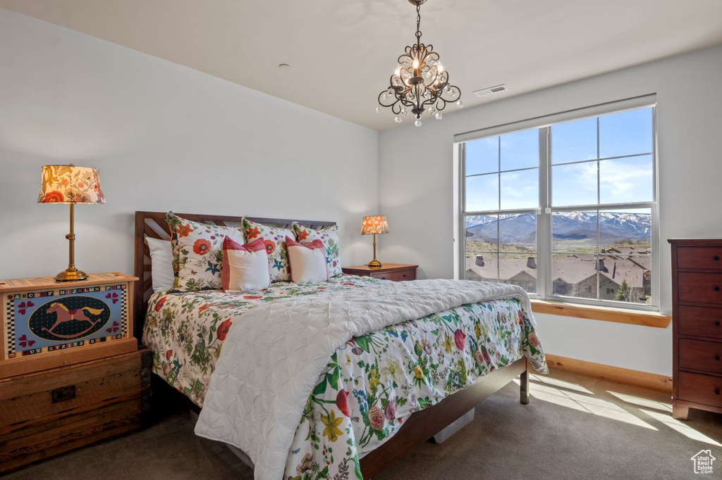 Bedroom featuring a mountain view, visible vents, an inviting chandelier, carpet floors, and baseboards