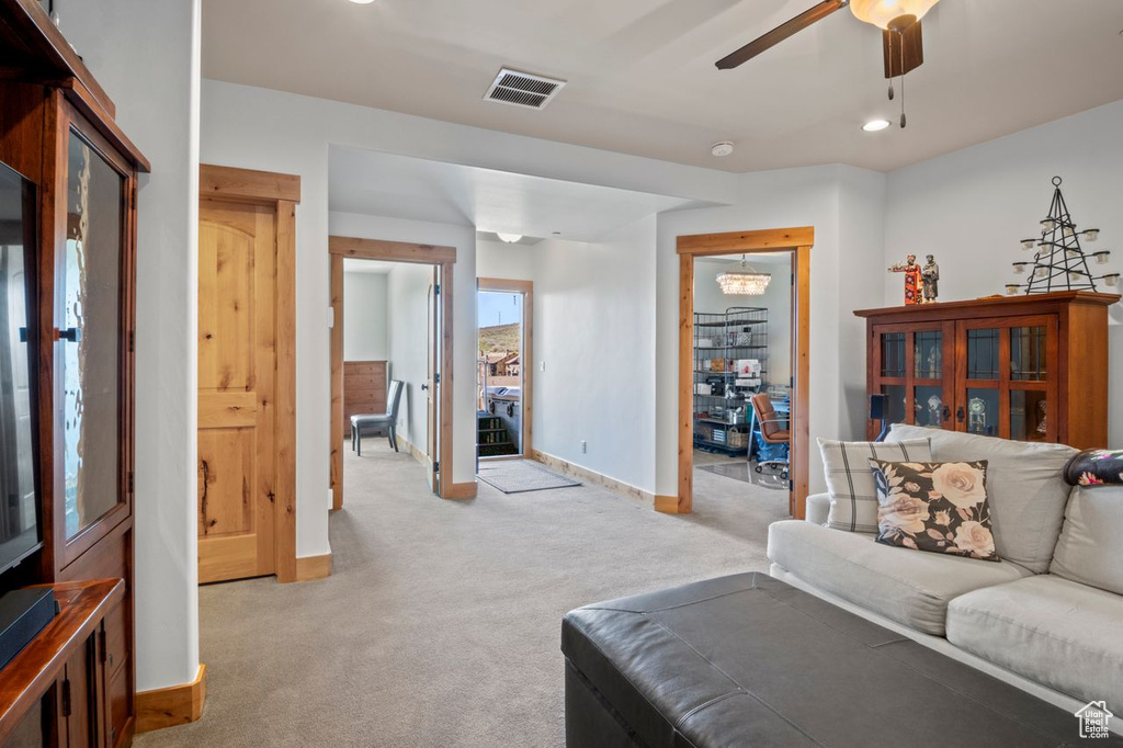 Living area featuring light colored carpet, visible vents, recessed lighting, a ceiling fan, and baseboards