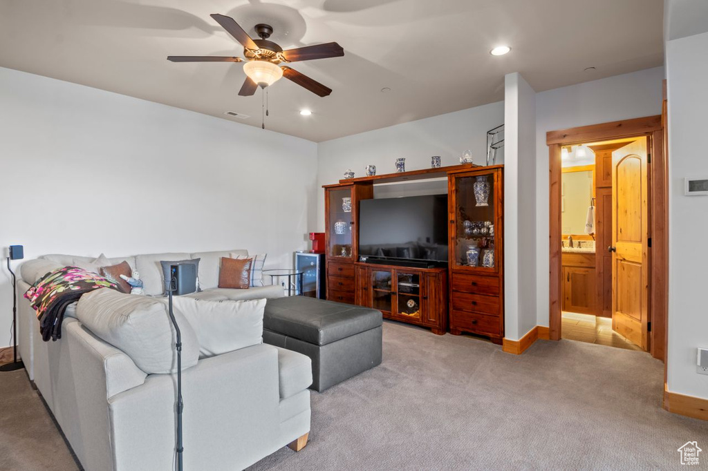Living room featuring carpet, baseboards, a ceiling fan, and recessed lighting