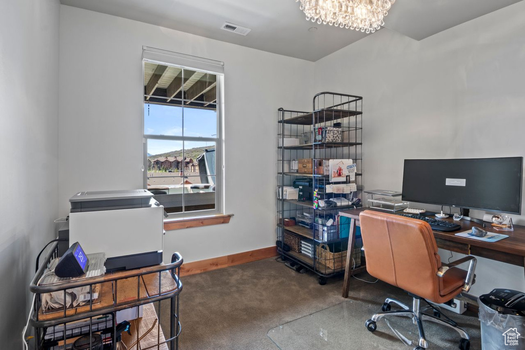 Office featuring carpet flooring, a notable chandelier, baseboards, and visible vents
