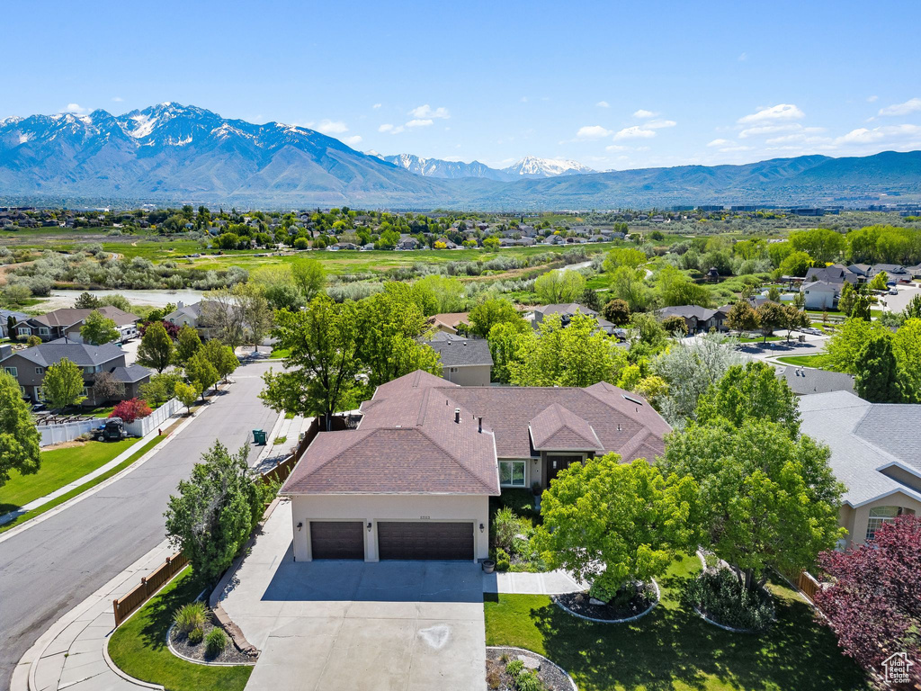 Aerial view of residential area featuring a mountainous background