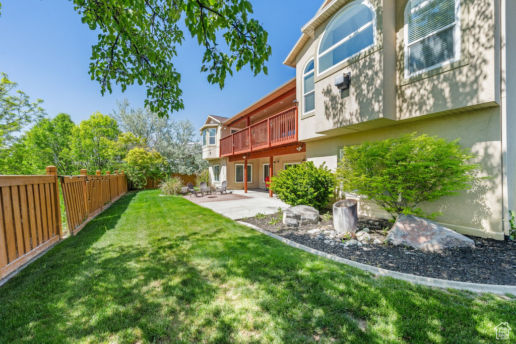 View of yard with a patio and a wooden deck