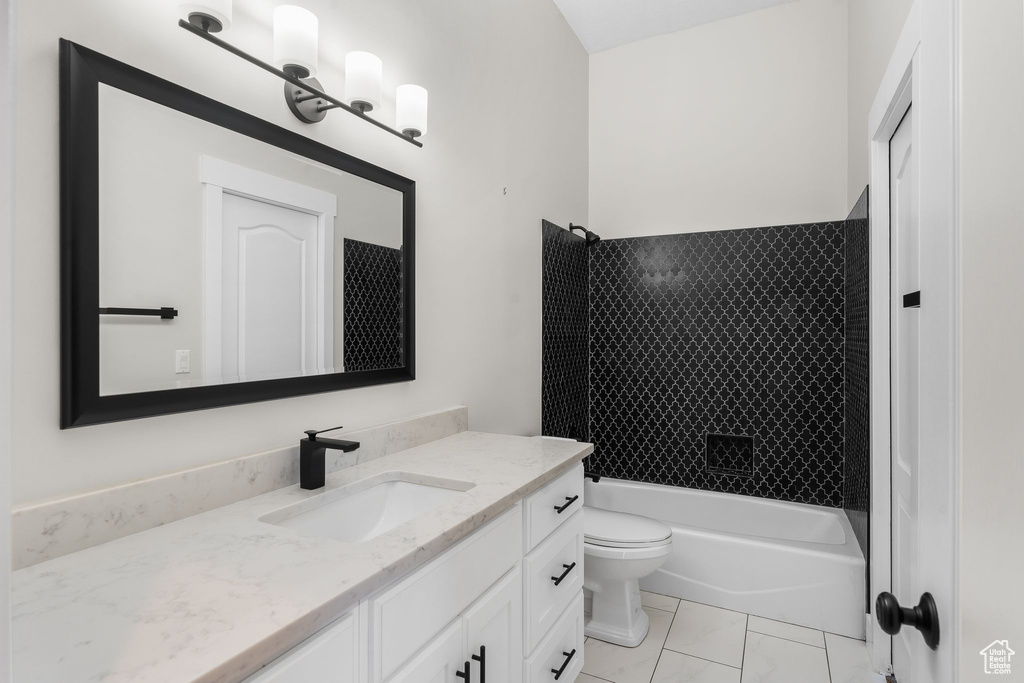 Full bath with toilet, vanity, and tub / shower combination