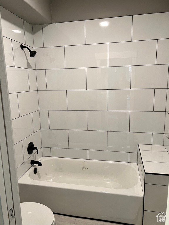 Full bath featuring toilet and shower / bath combination