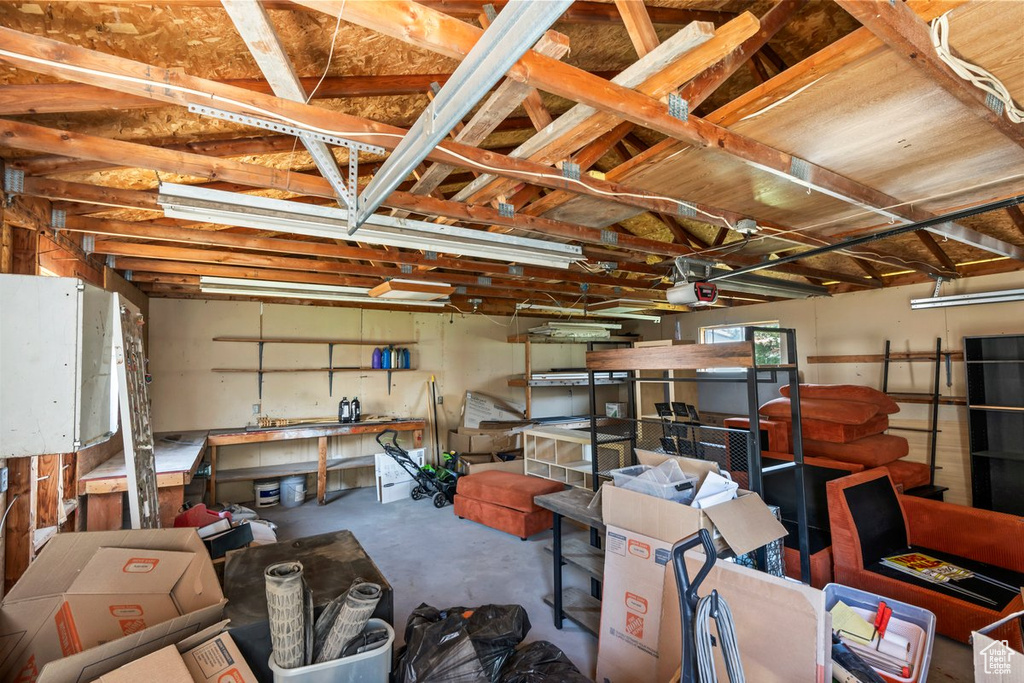 Garage with a garage door opener and a workshop area