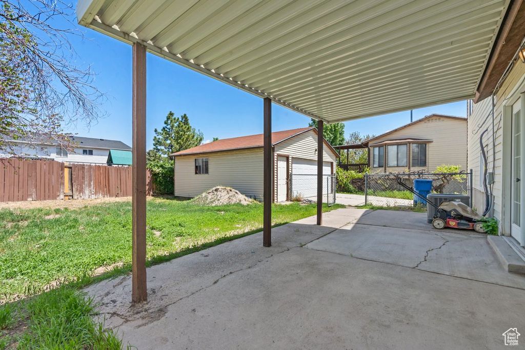 View of patio / terrace featuring an outbuilding and a garage