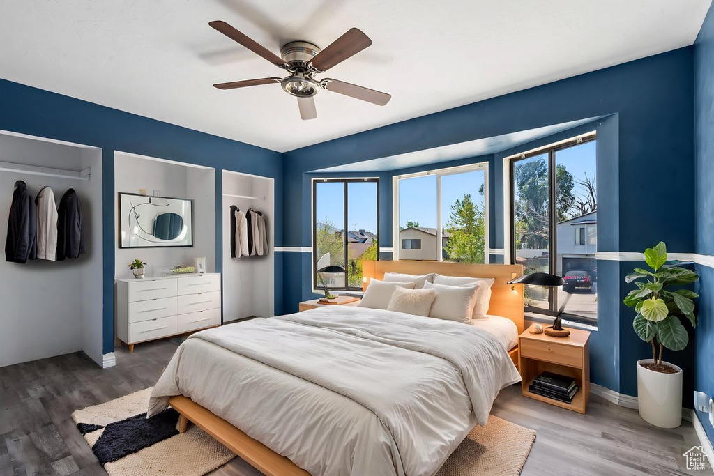 Bedroom with wood finished floors, baseboards, and ceiling fan