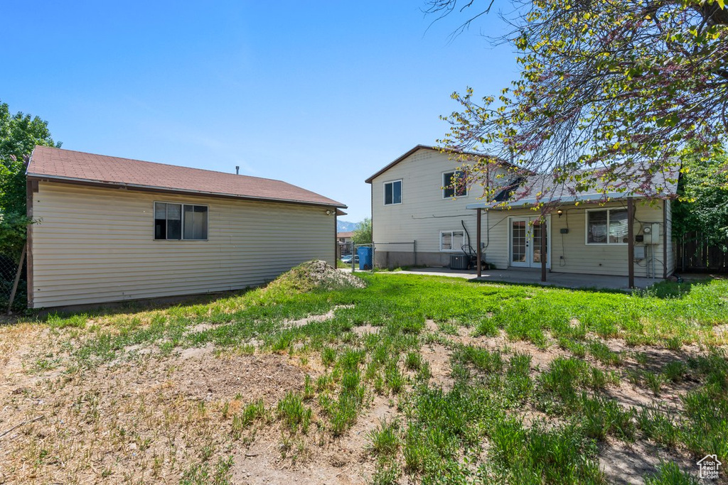 Rear view of property featuring french doors and a patio area