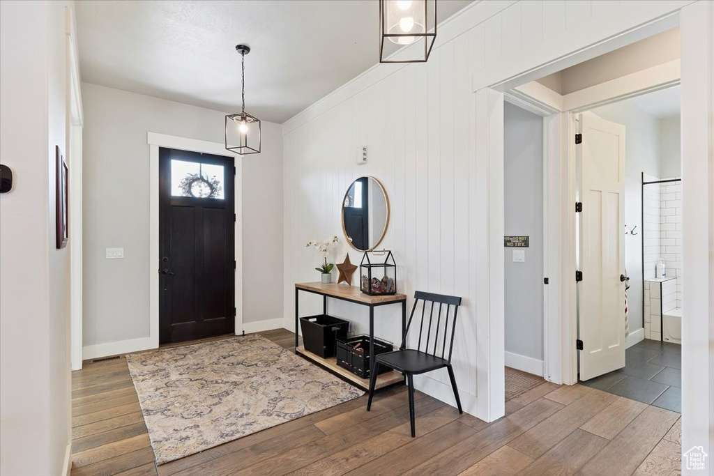 Entrance foyer with wood finished floors and baseboards