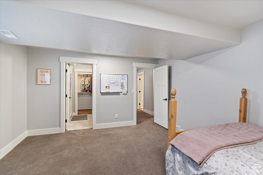 Bedroom with carpet floors and baseboards