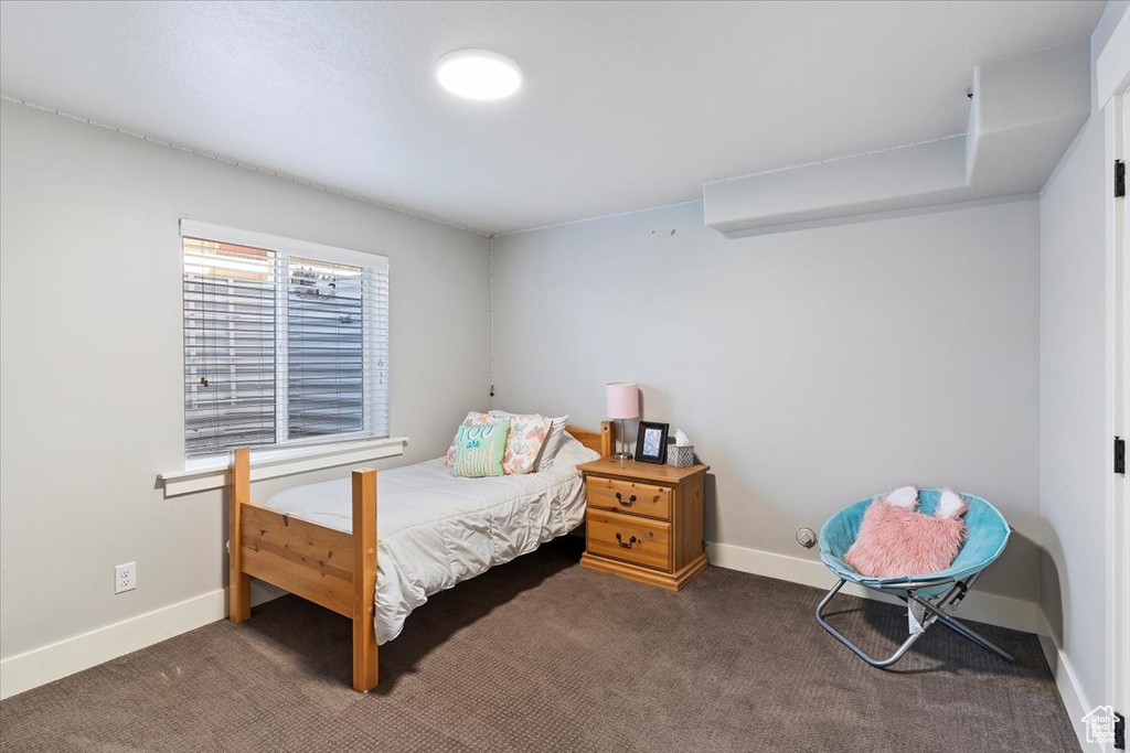Bedroom with carpet floors and baseboards