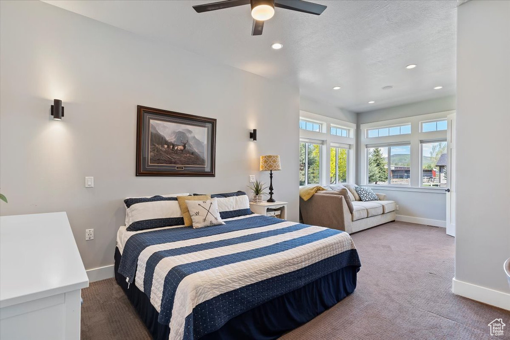 Carpeted bedroom featuring baseboards, recessed lighting, and ceiling fan