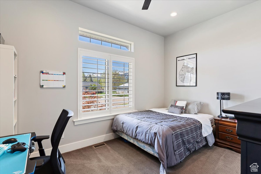 Carpeted bedroom featuring baseboards, a ceiling fan, and recessed lighting