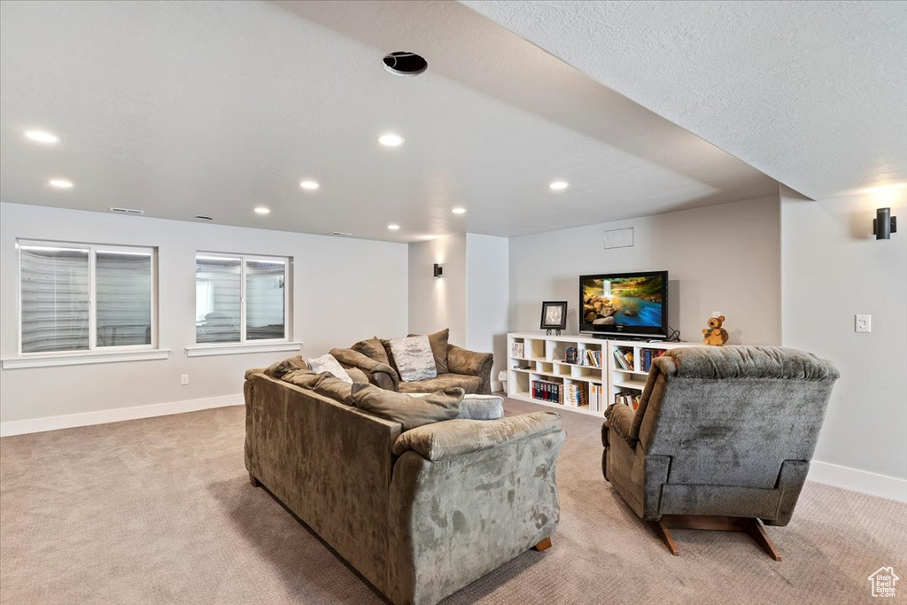 Living room featuring light carpet, recessed lighting, and baseboards