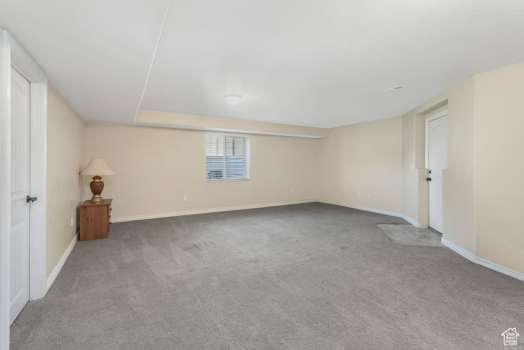 Basement featuring carpet and baseboards