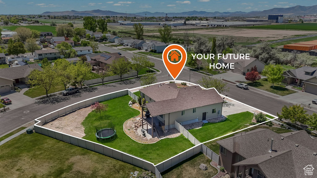 Aerial view of residential area with mountains and property parcel outlined
