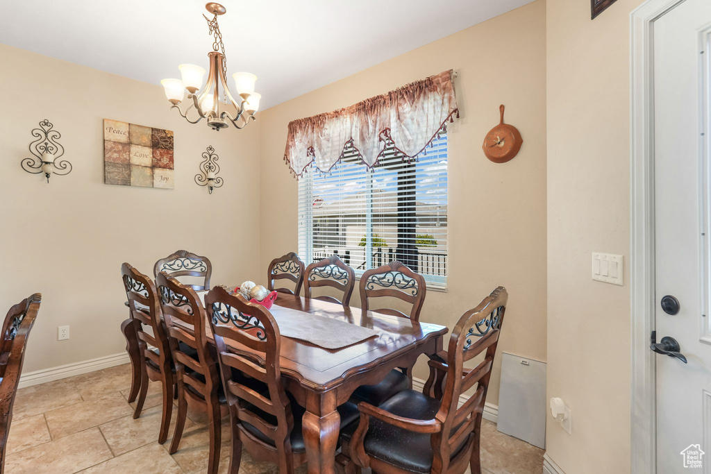 Dining space with a chandelier and baseboards