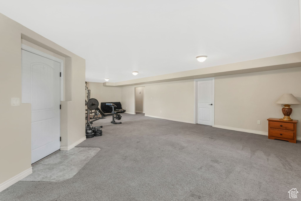 Exercise room with carpet flooring and baseboards