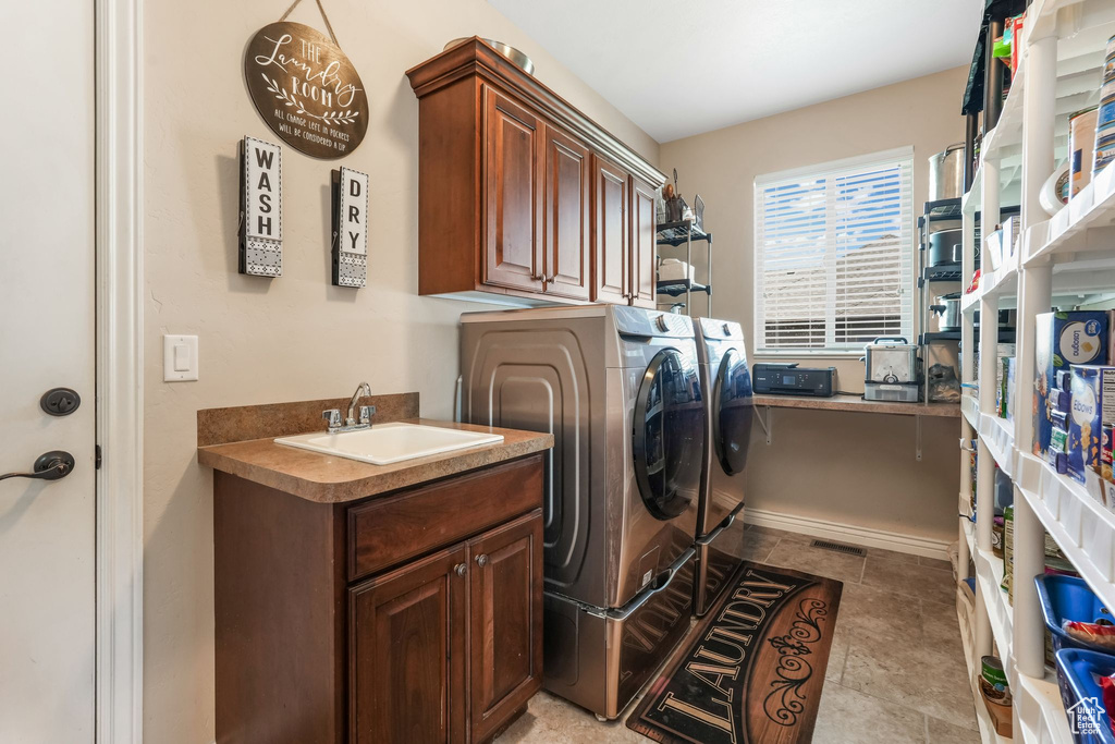 Clothes washing area with washing machine and dryer and cabinet space