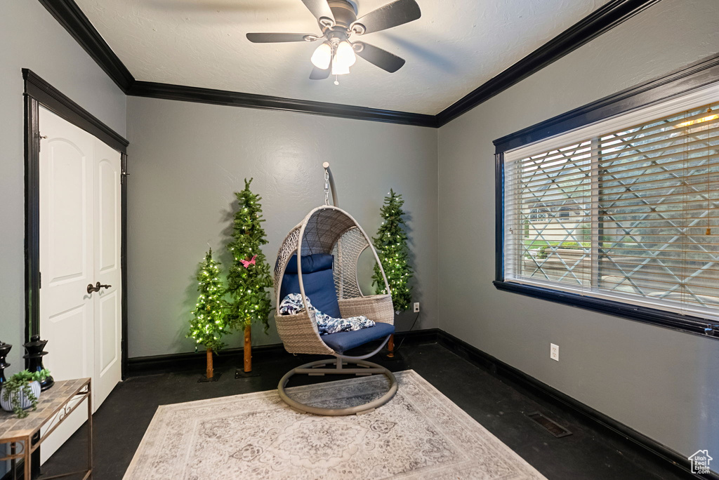 Sitting room featuring ornamental molding, a ceiling fan, and baseboards
