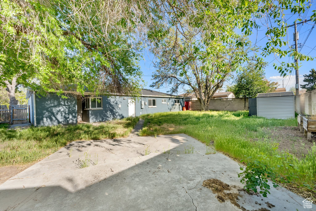 View of yard with fence and a patio area