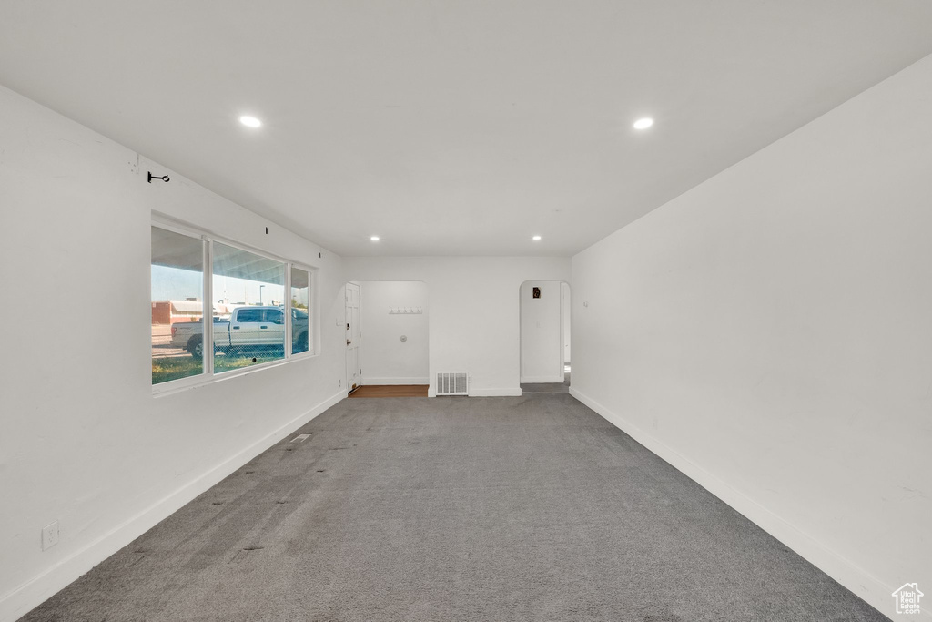 Carpeted empty room featuring recessed lighting and baseboards