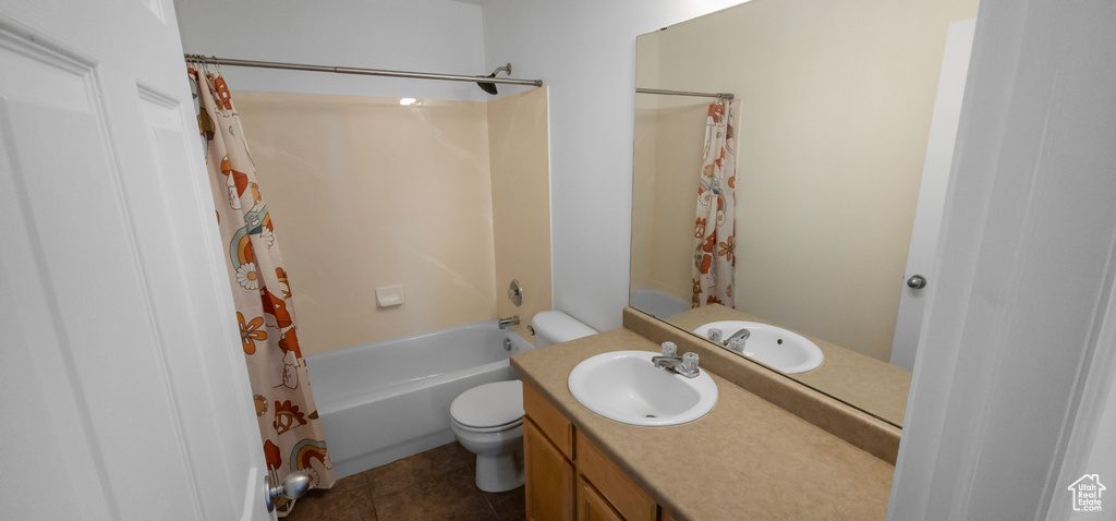 Full bath featuring toilet, vanity, shower / bath combination with curtain, and tile patterned floors