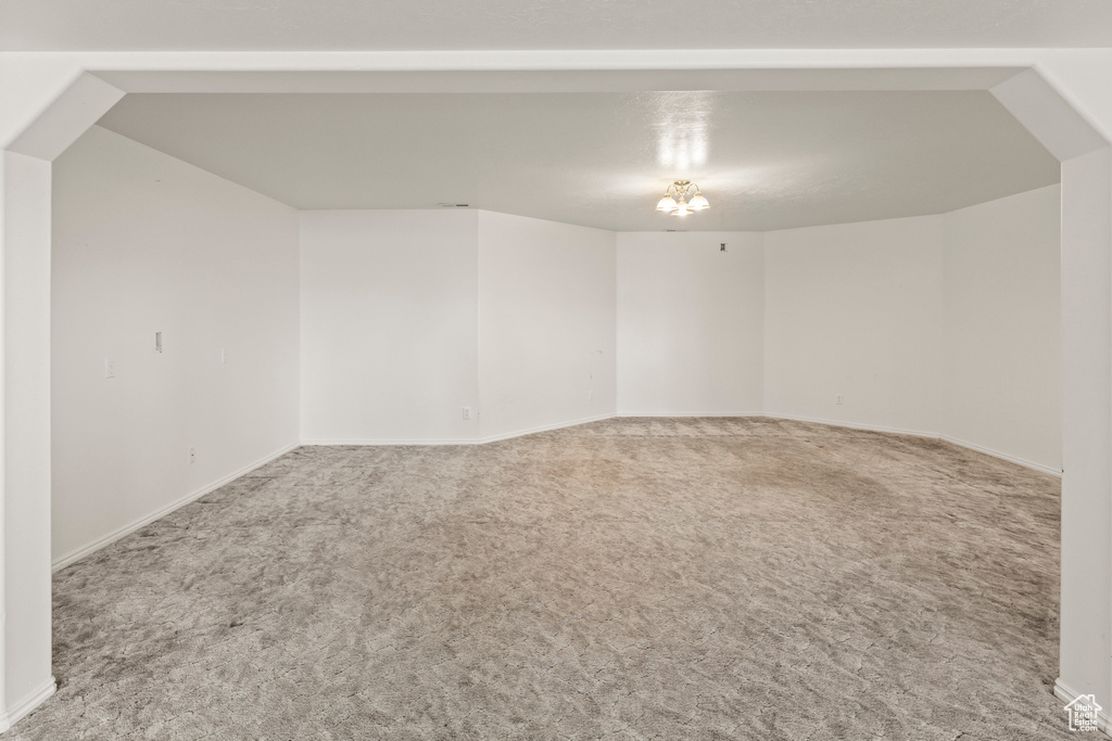 Carpeted spare room with baseboards