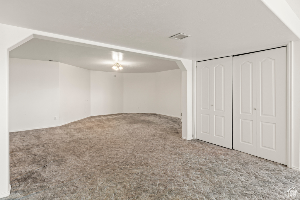 Below grade area featuring carpet floors and arched walkways