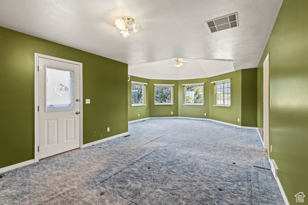 Unfurnished room with carpet flooring, a ceiling fan, and baseboards