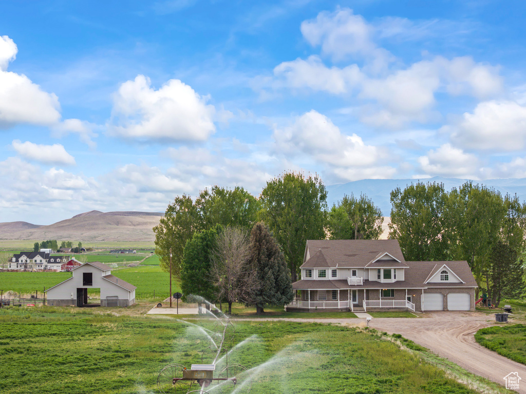 Surrounding community featuring driveway, a mountain view, a yard, and a garage